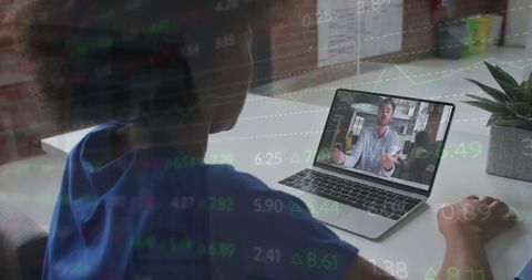 African American businesswoman intently participating in a laptop video call. Overlay of financial data charts in foreground highlights discussion relevance to finance or market analysis. Useful for depicting remote work and video conferencing culture, financial analysis, online business communication, and technology-driven workplace scenarios.