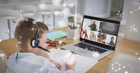 Boy with Headset Engaged in Online Education Session at Home