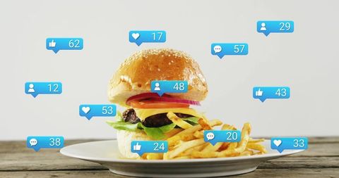 Viral Cheeseburger and Fries Showing Social Media Engagement Icons on Rustic Table