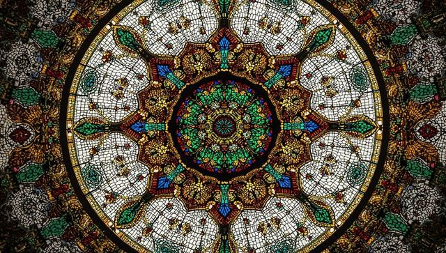 Intricate stained glass mosaic with central rosette