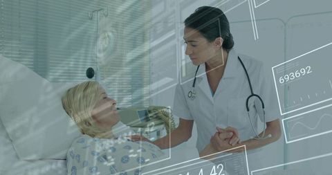 Nurse holding patient hand while monitoring digital vitals overlay for compassionate care