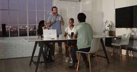 Diverse Business Team Collaborating in Modern Office Evening