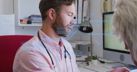 Mid-adult clinician explaining digital health data to patient during office consultation