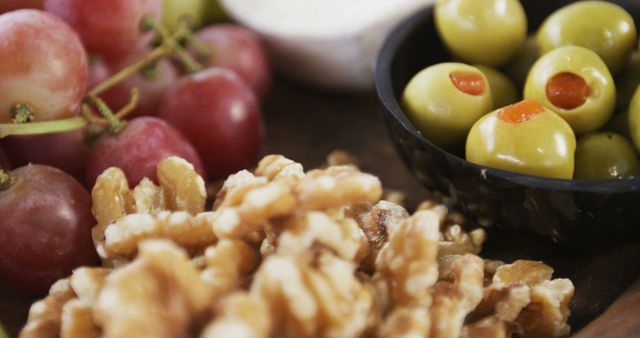 Close-up of Healthy Foods: Grapes, Walnuts, and Olives - Download Free Stock Images Pikwizard.com