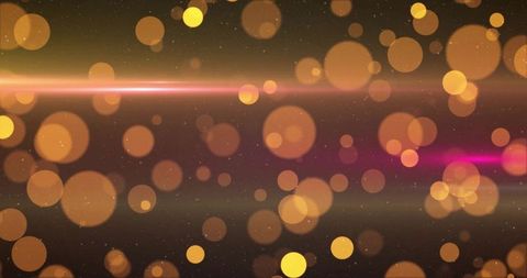 Golden Bokeh with Pink Lens Flare on Dark Background