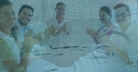 Professionals applauding success in boardroom meeting