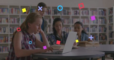 Teen students collaborating on laptop in school library with colorful geometric overlays
