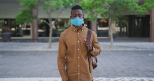 Young Man Wearing Mask Walking Outdoors During Pandemic - Download Free Stock Images Pikwizard.com