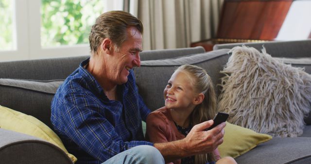 Cheerful Grandpa And Granddaughter Spending Quality Time With Remote Control - Download Free Stock Images Pikwizard.com