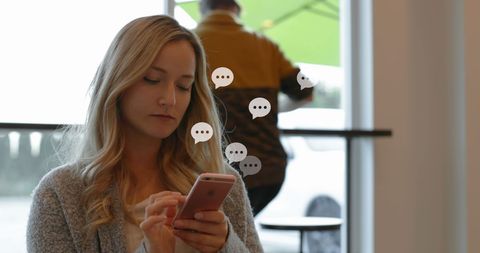 Young Woman Engaging with Smartphone Icons