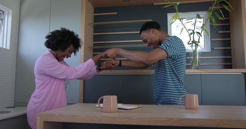 Happy couple sharing joyful moment in modern kitchen