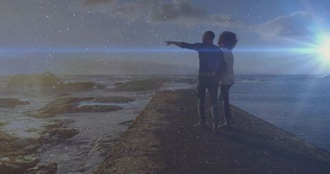 Couple Enjoys Romantic Nighttime View on Ocean Jetty