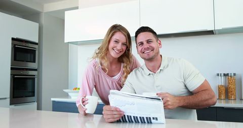 Smiling Couple Sharing Morning Coffee in Modern Kitchen