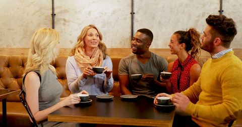 Diverse Friends Enjoying Coffee Together in Cozy Café
