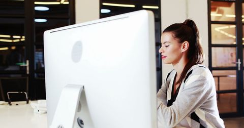 Professional Woman Engaged on Mobile Device in Modern Office - Download Free Stock Images Pikwizard.com