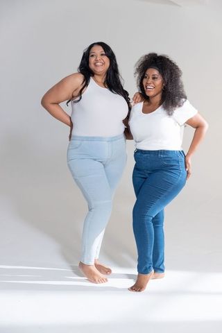 Confident multiracial plus-size friends wearing high-waist jeans and white tops
