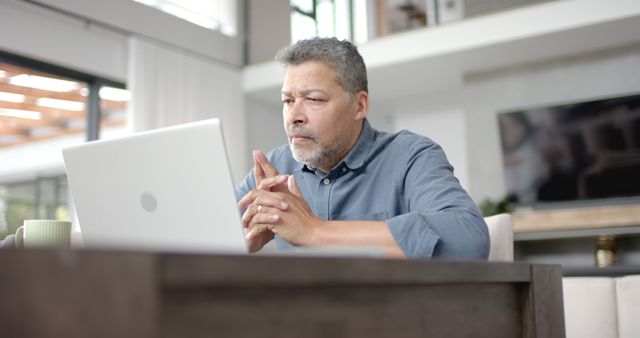 Focused Middle-Aged Man Working on Laptop at Home - Download Free Stock Images Pikwizard.com