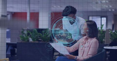 Coworkers Collaborating with Digital HUD Overlay in Modern Office Workspace