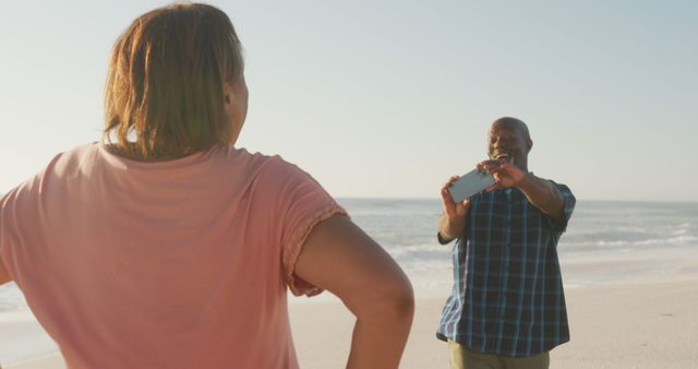 Couple Enjoying Photography at Beach During Sunny Day - Download Free Stock Images Pikwizard.com