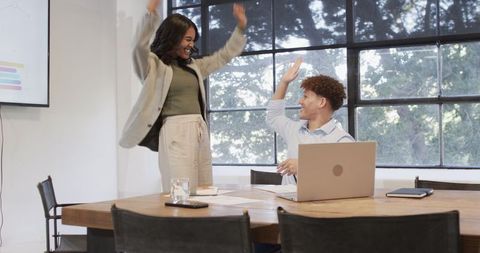 Joyful Office Team High Five Celebrating Achievements