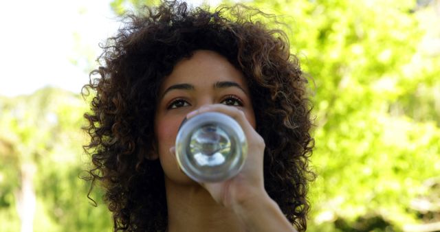 Young Woman Drinking Water Outdoors on a Sunny Day - Download Free Stock Images Pikwizard.com