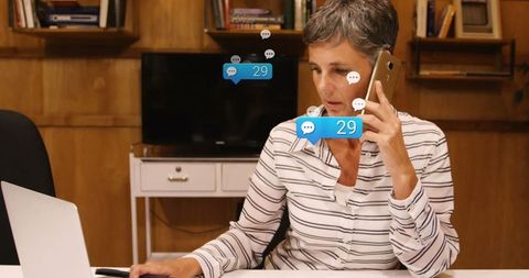 Middle-Aged Professional Woman Engaging in Multitasking with Tech Gadgets