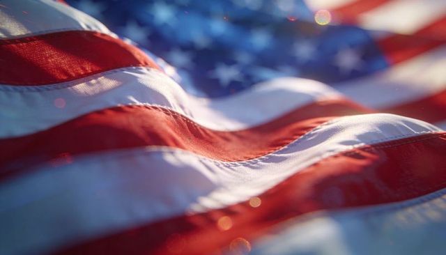 Rippling american flag fabric closeup with sunlight bokeh, stitched seams and texture