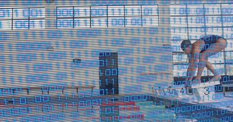Competitive Swimmer Preparing on Starting Block with Binary Data Overlay for Sports Tech