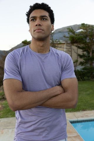 Athletic Man Relaxing Near Backyard Pool