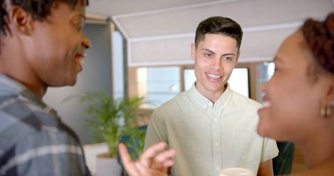 Diverse Coworkers Chatting in Modern Office Environment