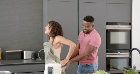Joyful Couple in Modern Kitchen Enjoying Cooking Together