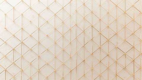 Creating elegant gold lattice wall panel forming geometric luxury interior backdrop