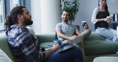 Colleagues Enjoying Coffee Break in Relaxed Office Environment