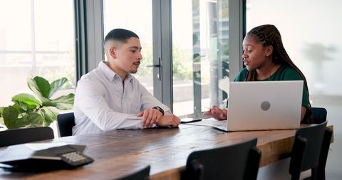 Diverse professionals brainstorming at office meeting