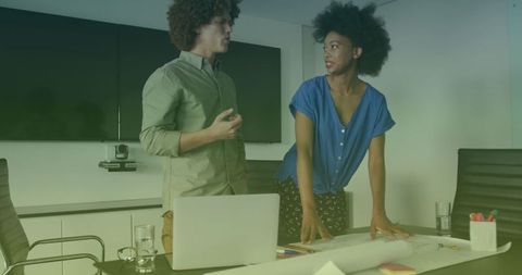 Diverse colleagues engaged in discussion over project plans