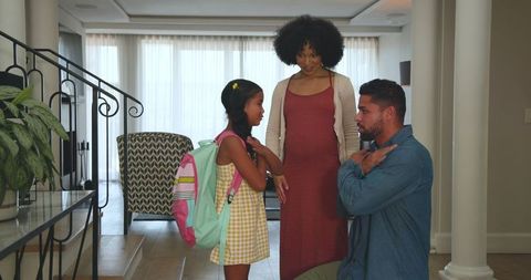 Father, Mother, and Daughter Bonding at Home Before School