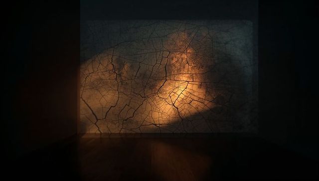 Abstract glowing fracture pattern on dark wall with amber glow