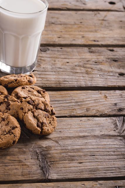 Cookies by glass of milk on wooden table with copy space. unaltered, food, drink, healthy eating and snack.