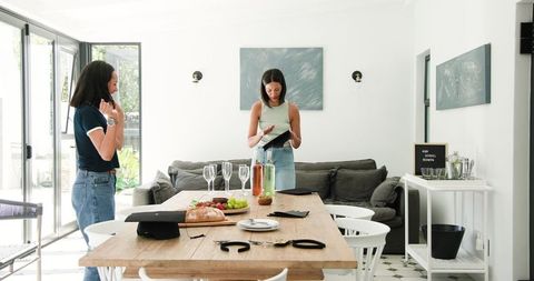 Friends Preparing a Dining Table for Graduation Celebration