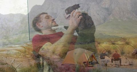 Reclining man holding dog on tufted sofa overlaid with scenic mountain camping landscape