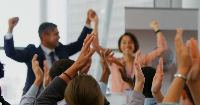 Cheering and applauding business team in a modern office environment. Ideal for illustrating corporate success, team building, and positive work culture. Perfect for use in business presentations, corporate websites, and productivity blogs.