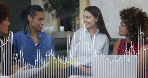 Diverse team collaborating over data charts and laptop for business analytics review