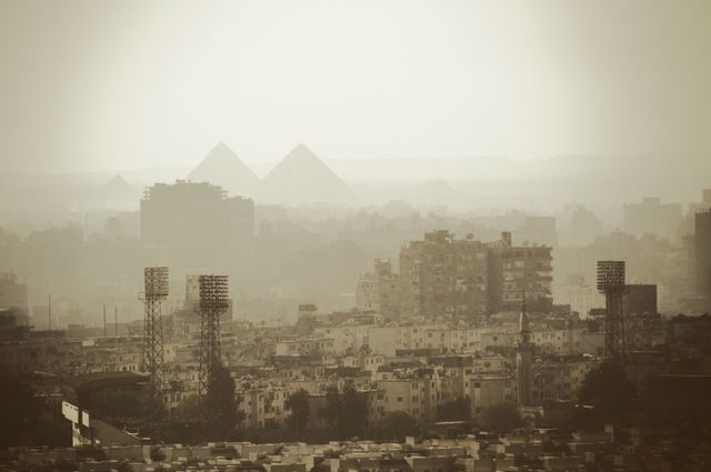 Hazy Cityscape with Egyptian Pyramids in Background - Download Free Stock Photos Pikwizard.com