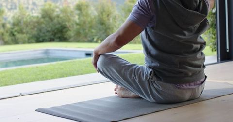 Senior Man Meditation by Poolside in Tranquil Setting