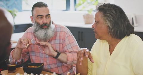 Diverse Senior Friends Sharing Mealtime and Engaging Conversation