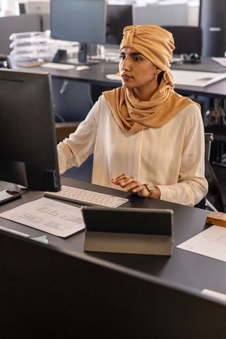 Indian woman using technology in modern office environment