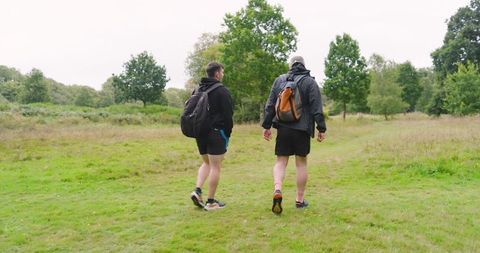 Two Friends Hiking in Green Park with Backpacks - Download Free Stock Images Pikwizard.com