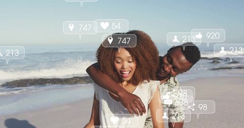 Happy Couple Embracing on Beach with Social Media Engagement