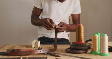 Artisan Crafting Leather Belt in Workshop with Tools