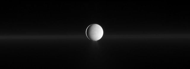 Enceladus, Saturn's moon, spewing water ice from its south polar region and showing Saturn's faint G ring. Useful for educational content, astronomy blogs, space documentaries, space-related projects, and scientific presentations.